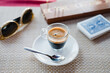 © Jarusha Brown Photography/Stocksy - Small cup of espresso on table with cribbage board.