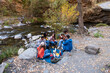 © Bisual Studio/Stocksy - Friends doing picnic and playing guitar outdoors