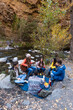 © Bisual Studio/Stocksy - Friends doing picnic and playing guitar outdoors