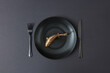 © Yaroslav Danylchenko/Stocksy - Served table set with golden fish on ceramic plate.