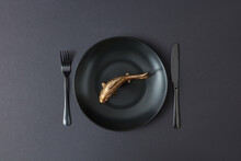 Served Table Set With Golden Fish On Ceramic Plate.