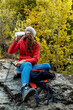 © Bisual Studio/Stocksy - Woman drinking water at nature on autumn day