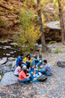 © Bisual Studio/Stocksy - Group of friends having a picnic in a forest