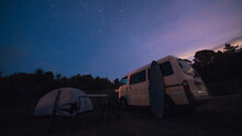 Campsite Under The Stars With Van And Surfboard