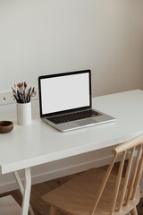 Wall Mural - Blank screen laptop computer. Home office desk table workspace. Modern minimal Scandinavian interior design. Blog, magazine, web, social media template with copy space mockup.