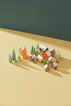 Miniature Houses And Trees On Color Background.