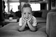 © Jakob Lagerstedt/Stocksy - Cute young boy with a crazy hairdo laying on a couch