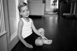 © Jakob Lagerstedt/Stocksy - Cute young boy in a tanktop sitting on the floor