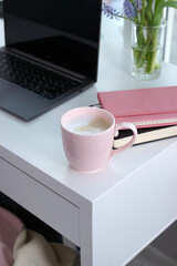 Wall Mural - Pink mug with coffee on white desk