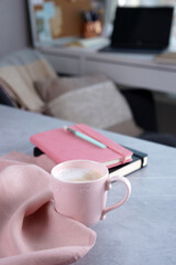 Wall Mural - Pink mug with coffee on grey desk