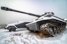 Tank And Military Equipment On The Snow On A Gray Background Sky, Blurry Image