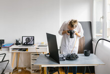 Female Photographer Working In A Studio