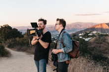 A Cinematographer And Director Film During Golden Hour