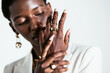© BONNINSTUDIO/Stocksy - Ethnic woman in stylish rings on fingers in studio