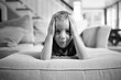 © Jakob Lagerstedt/Stocksy - Cute young boy laying on a couch making a funny expression