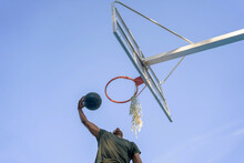 Young Man Making A Basketball Dunk.