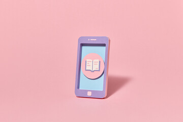 Papercraft smartphone screen with the book icon.