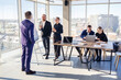 © DSMT - Confident businessman makes a presentation of a new project in the boardroom at a company meeting. Beautiful auditors talk with different partners about the business using a whiteboard and graphs.