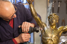 Craftsman Repairing A Statue