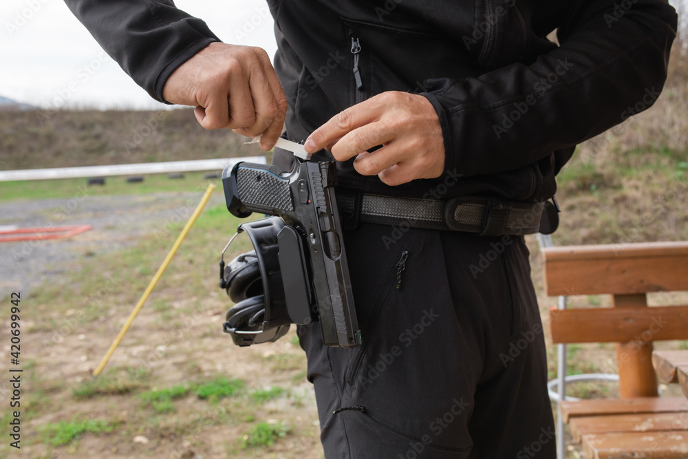 One shooter is preparing his gun for practical shooting training Stock ...