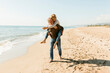© Valentina Barreto/Stocksy - Happy couple piggyback at the beach