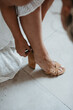 © Melissa Milis Photography/Stocksy - bride putting on blush high heels