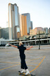 © Victor Bordera/Stocksy - Stylish man skating on heels through Dallas downtown