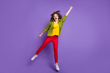 Wall Mural - Full size photo of young happy smiling cheerful excited crazy girl with curls jumping isolated on violet color background