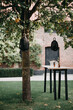 © Melissa Milis Photography/Stocksy - small table in a garden with black lanterns