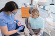 © Hernandez & Sorokina/Stocksy - Dentist Showing Correct Teeth Cleaning To Patient