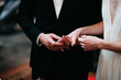 © Melissa Milis Photography/Stocksy - bride with cleavage and groom with classic suit in church holding hands