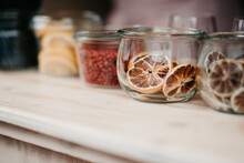 Dried Oranges, Peppers And Lemon In Glass Jars