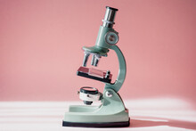 Small Microscope On A Pink Background