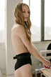 © Julie Meme/Stocksy - Blonde girl in underwear in front of the window