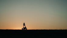 Silhouette Of A Man Standing On The Motorcycle