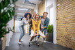 © zinkevych - Group of young people riding the chair in the office corridor after a nice day