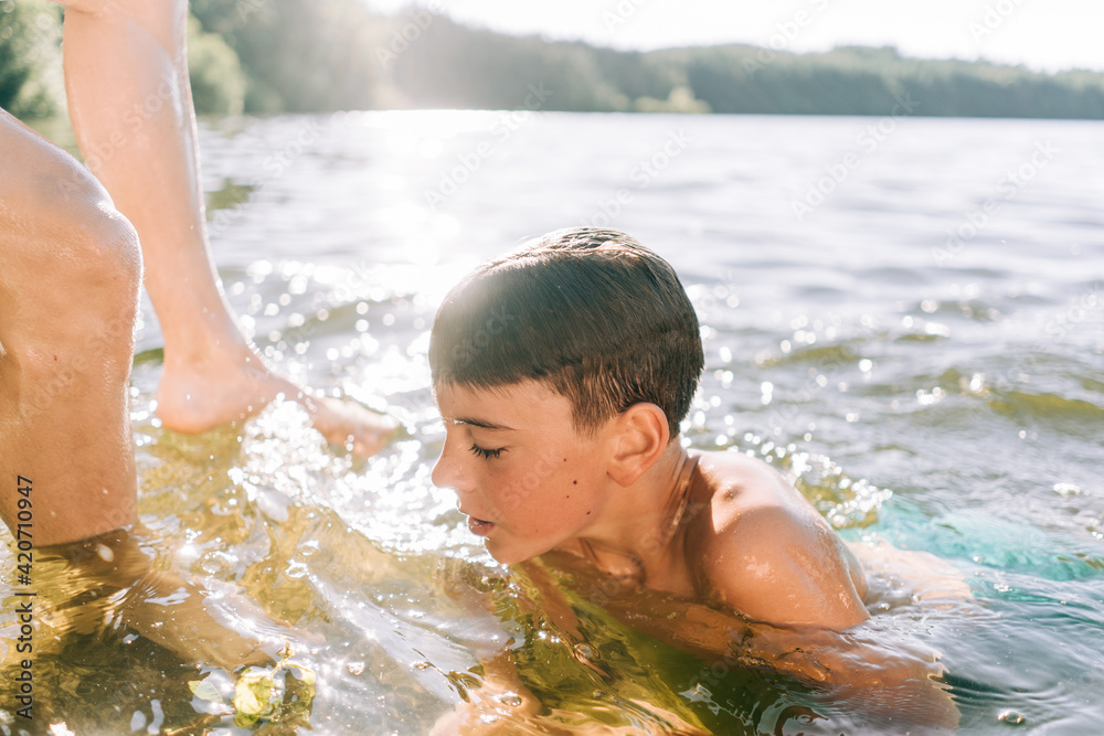 boy swimming in a lake Stock Photo | Adobe Stock