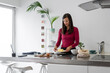 © Bisual Studio/Stocksy - Woman cooking in a modern kitchen