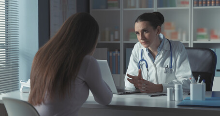 Wall Mural - Caring doctor assisting a young patient in the office