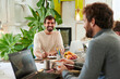 © Ivan Gener/Stocksy - Smiling designer talking with coworkers