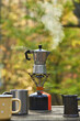 © Yaroslav Danylchenko/Stocksy - Traditional Italian coffee maker on a camping gas stove.