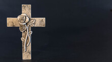 Religious Cross With Flower Ornate  With On A Dark Background With An Ornate Cross.
Mourning Moment At The End Of A Life. Last Farewell. Funeral Concept. Plenty Of Copy Space For Religious Sayings. 