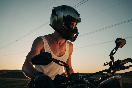 Portrait Of A Motorcyclist With Helmet In The Sunset