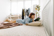 © Mihajlo Ckovric/Stocksy - Young woman reading a book in her bedroom