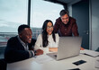 © StratfordProductions - Happy multiethnic group of business people looking at laptop discussing new project in office