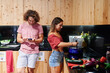 © Ivan Gener/Stocksy - Couple making dinner in a hostel kitchen