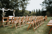 Beautiful Outdoor Wedding Ceremony Set Up With Wooden Folding Chairs