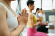 © zheng long/Stocksy - Young women practice yoga in a yoga studio