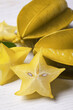 Delicious carambola fruits on white wooden table