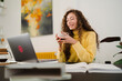 © Studio Marmellata/Stocksy - Young student with hot drink doing homework